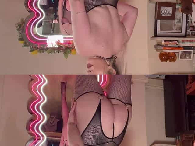 Blond explores sensual solo in fishnets passionate display