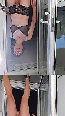 Pointing on the balcony in underware