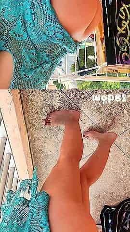 My wife is drying off on the balcony in Spain just after the beach and is a little shy