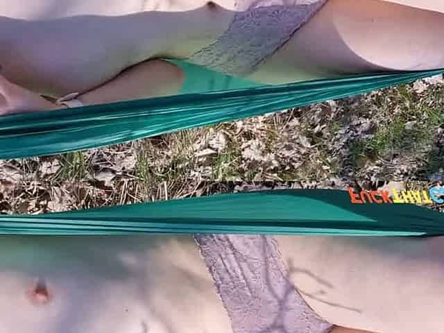 Teen girl caught masturbating in a hammock outdoors.