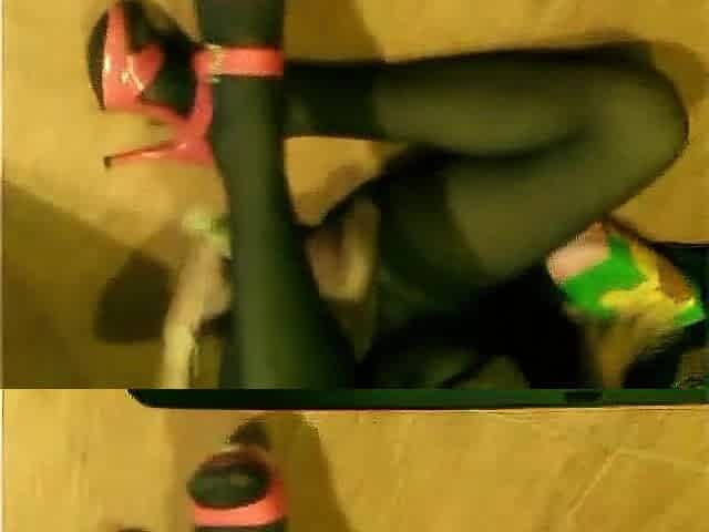 Sissy t-girl doxy in brown hose, green costume, red heals, lengthy sex toy