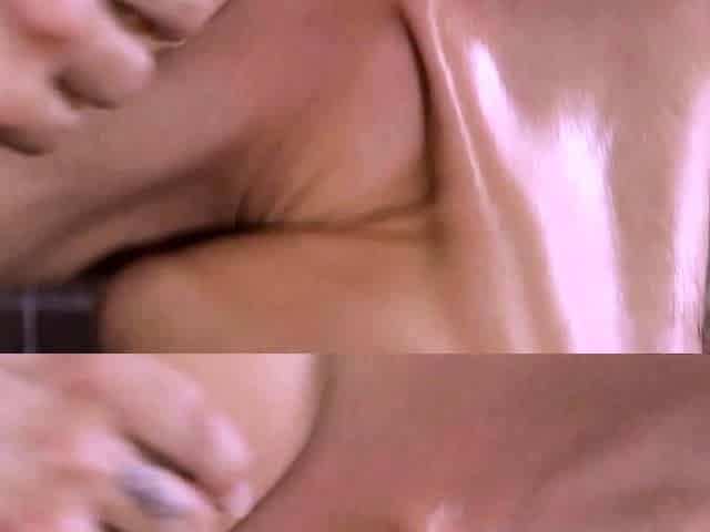 Tanned oiled brunette with big boobs fingers her shaved vag