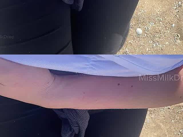 Hand expressing breastmilk at the beach!