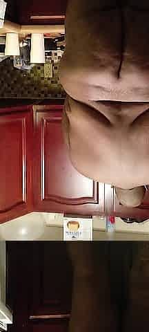 Nudist doing dishes