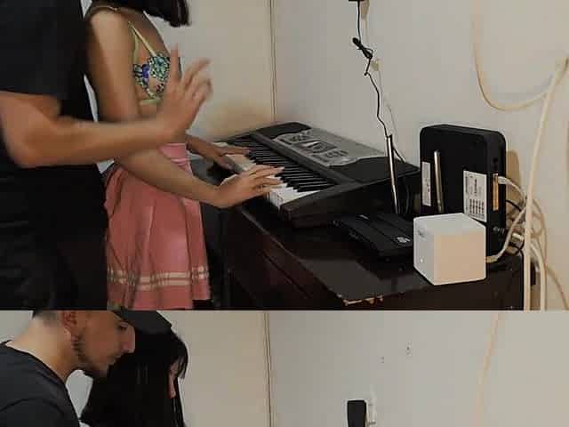 Gorgeous youthful woman in pink petticoat drilled up wanting to play piano