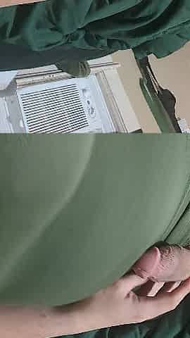 Stroking in a green costume and fake boobs