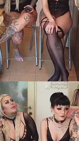 Tattooed ladies smoking in the kitchen