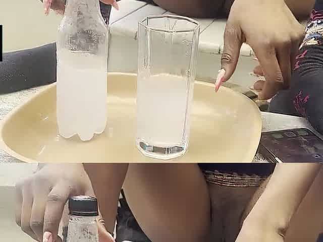 Black cutie displays her hairless twat during the time that enjoying drinking