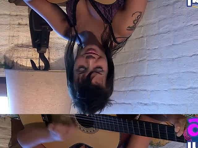 Sexy Paul showing her medium breasts and vagina with guitar