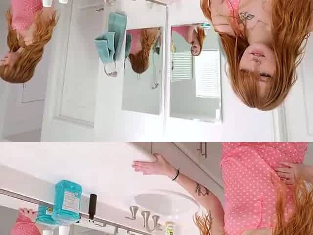 Redhead girl loves gargle in bathroom