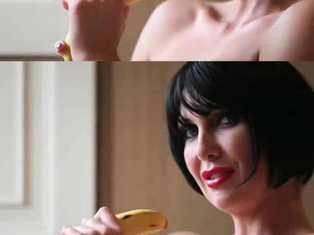 Leigh Darby with ebony hair shows her skills with a banana
