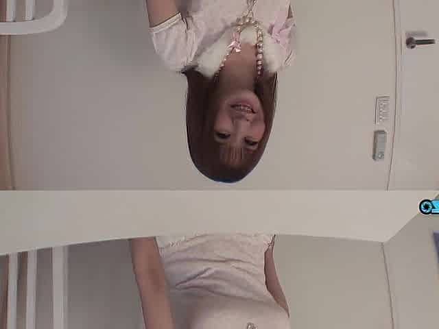 A solitary red-haired Oriental beauty engages in self-stimulation inside the flat