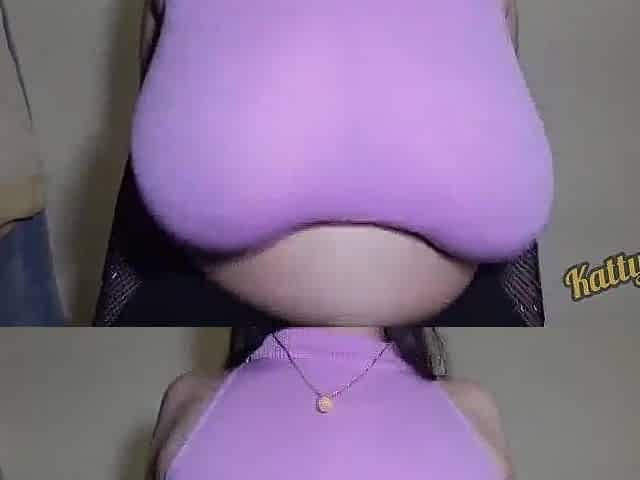 Katty Milk shakes her giant natural titties in pink clothing in front of the camera / Taking off raiment