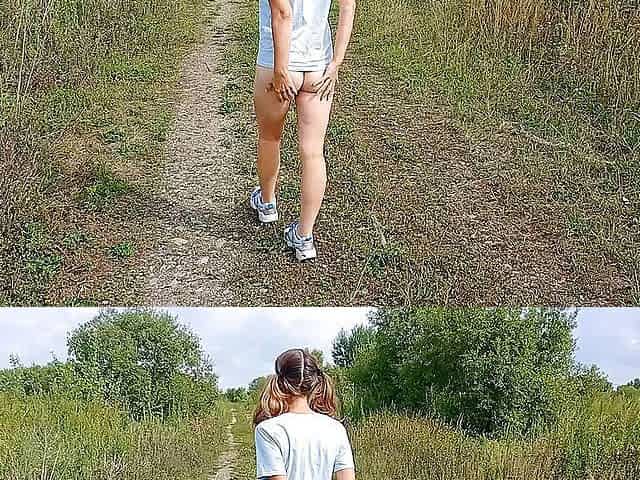 Bottomless girl with pigtails walks along a country road