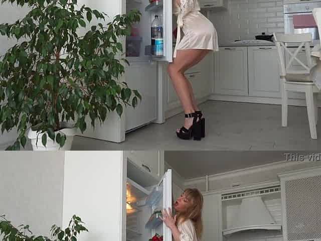 Fridge Humping. Nice-looking woman having enjoyment at home