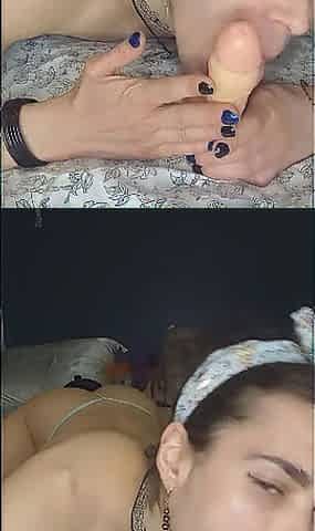 Sucking her dildo in bed