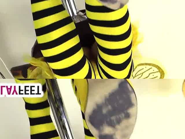 Cosplayer lility is wearing a yellow and ebony bee dress, with yellow high heels and striped socks