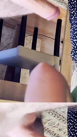 A girl with a tattoo on her arm licks her boyfriend's dick at home