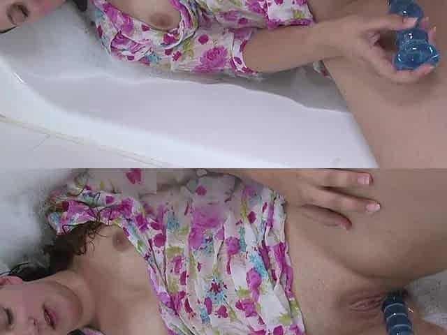 Long Haired Brunette Girl Takes Bath with Her Dress on and Masturbates Using Her Sex Toy