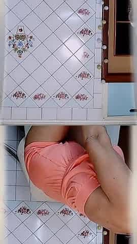 Elderly Housewife Lukerya in the Kitchen. Cheerful Flirtation