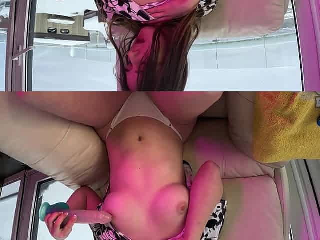 Brunette with long hair fingers her pussy on the couch