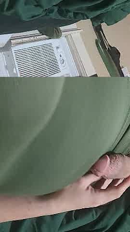 Wanking in a green suit and fake tits