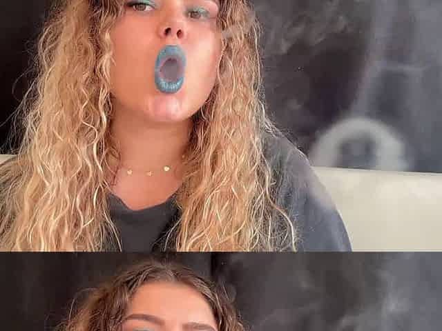 Exotic goddess with wild hair blows smoke for you