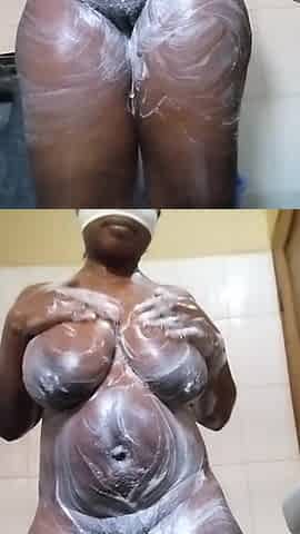 Curvy black woman bathing