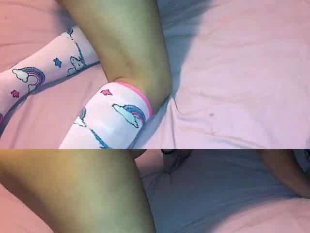 Pink labia close up of naive brunette playing with her name
