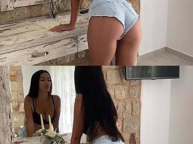 Brunette hair with large melons masturbates in front of the mirror