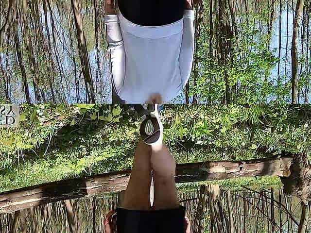 Pretty woman walking stripped with a clitoris pump outdoors in a public forest