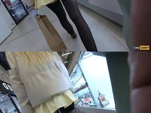 A beauty walks in a short petticoat out of pants in a shopping mall