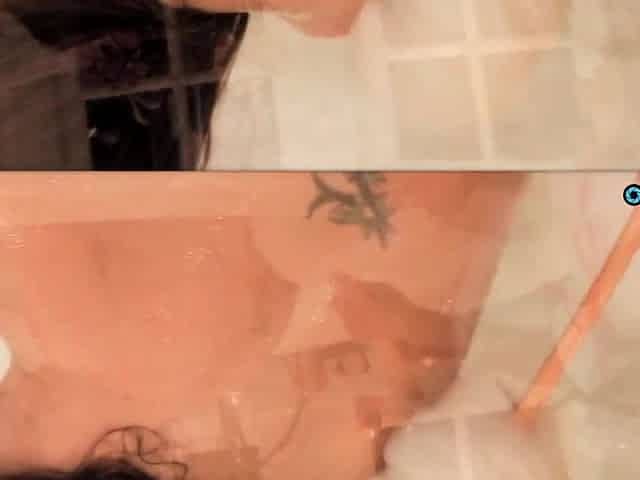 Lesbo bathtub play with sex-toy and giving a kiss