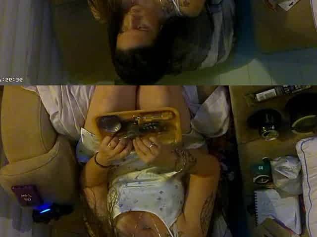 Breasty beauty in pink brassiere and pants smokin' and playing movie games