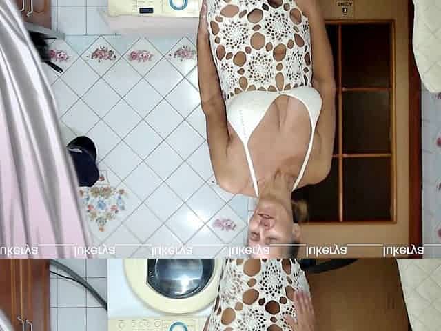 Lukerya is wearing a white openwork dress