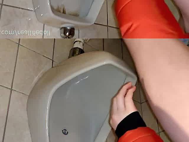 Gril peeing in the urinal