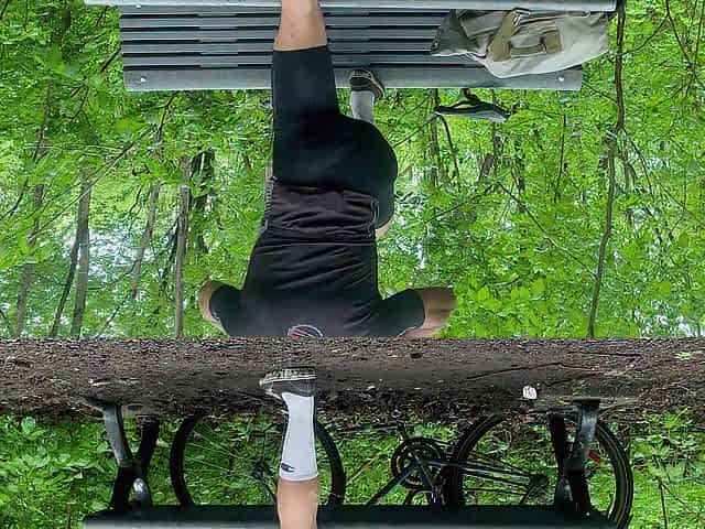 Biker In Spandex Stretching At The Park
