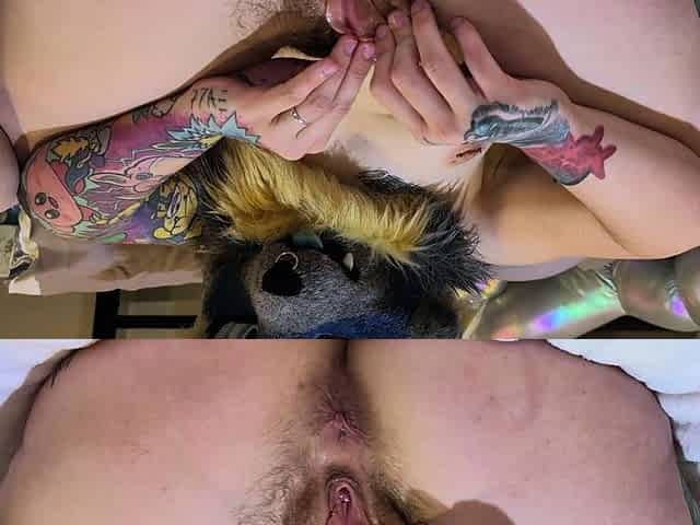 Girl with bush plays with dildo in fursuit, laying on back
