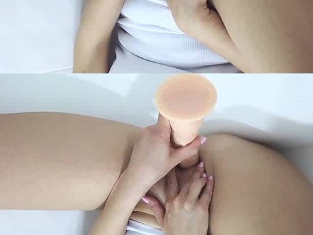Pee on a large sex-toy in the bath of her moist cunt close up
