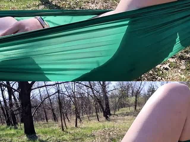Teen girl caught masturbating in a hammock outdoors.
