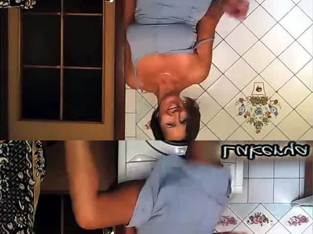 A Housewife at Home in the Kitchen Sits on the Washing Machine and Points to the Camera Her Magnificent Breasts