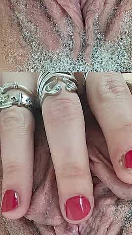 Rubbing stretching pulsing pink cunt in washroom close up