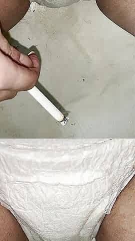 Cutie having a smoke whilst peeing in her diaper