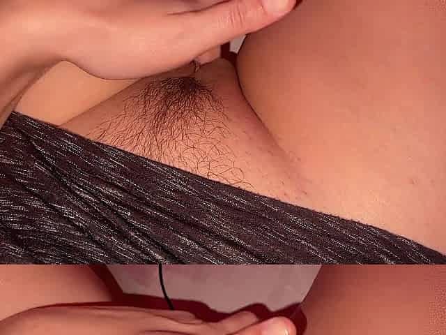 The cutie plays with her curly twat intensely, masturbating with her fingers and making squelching sounds.
