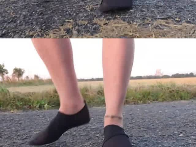 Light-colored tights and beach shoes in the puddle
