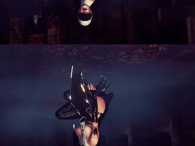 Concupiscent aged nun in ebony costume solo posing out of pants in cathedral