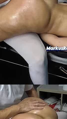Masseur Spanking Her Wide Hips on Massage Bed