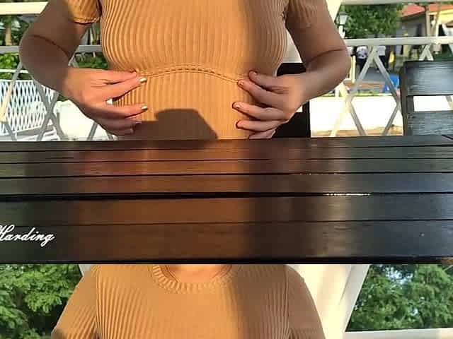 Alice in a beige dress sits in a bar walking down the street and posing near the mirror showing breasts