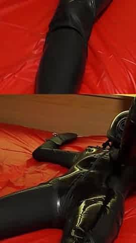 Oil body in latex catsuit