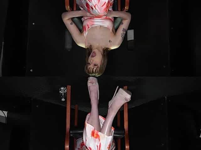 Backstage with tattooed solo model Rebecca Vanguard through a gloryhole